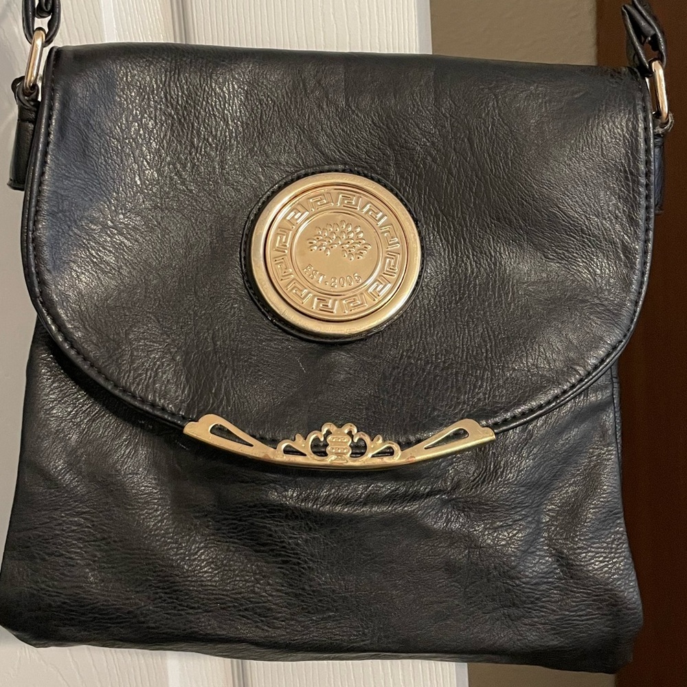 Black Crossbody Purse with Gold colored accents.
